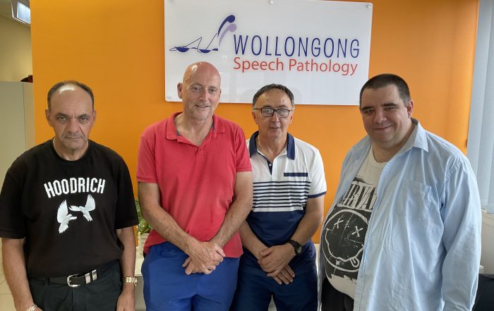 Group of four men with brain injuries in a speech pathology clinic.