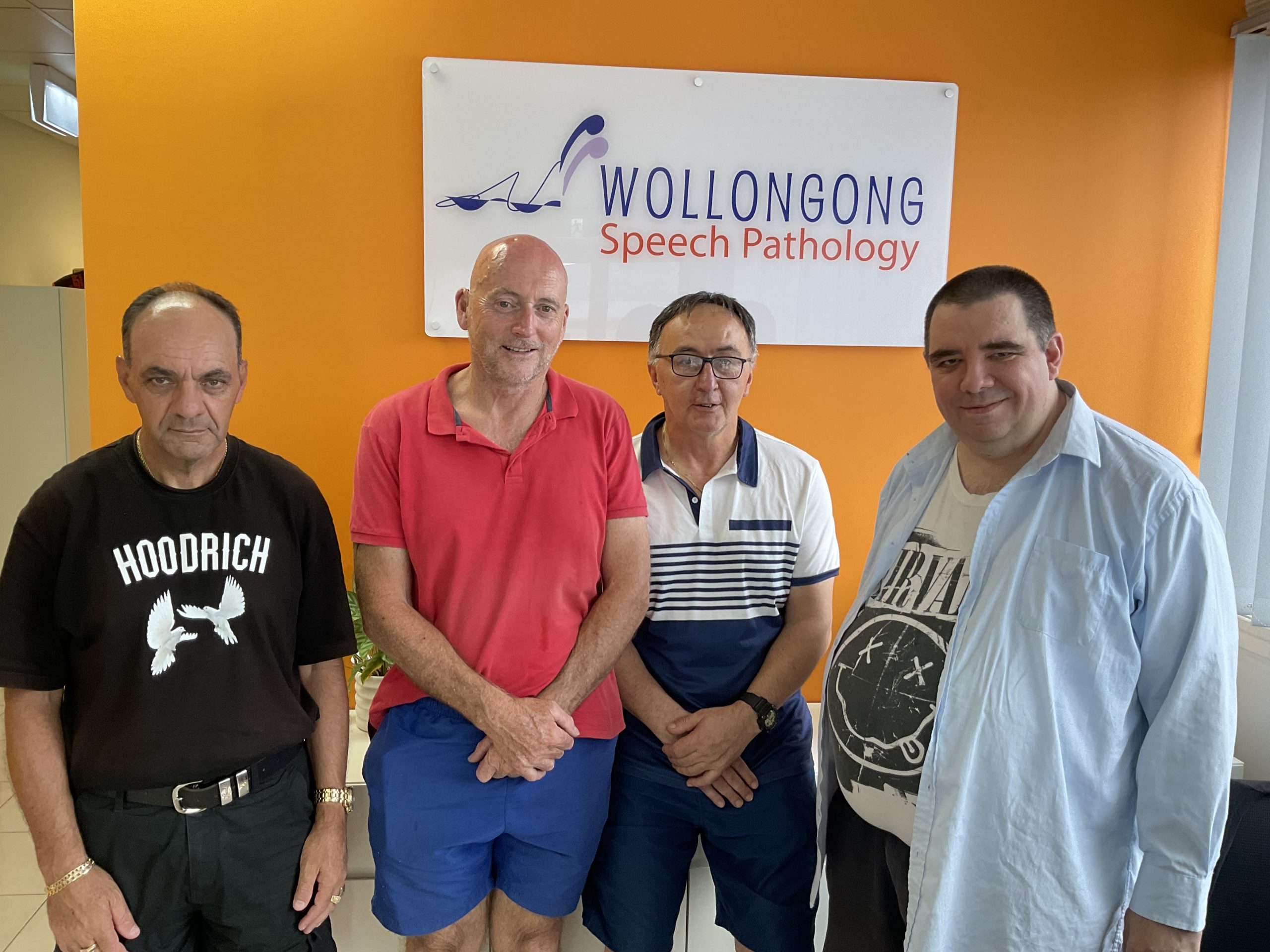 Group of four men with brain injuries in a speech pathology clinic.